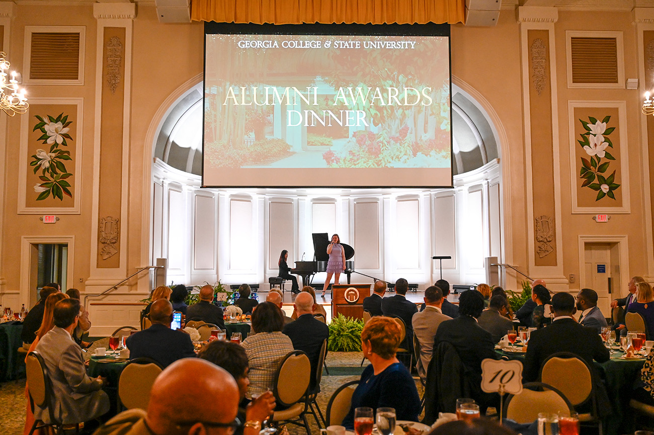 Attendees enjoy a performance by junior music education major Riley Greer.