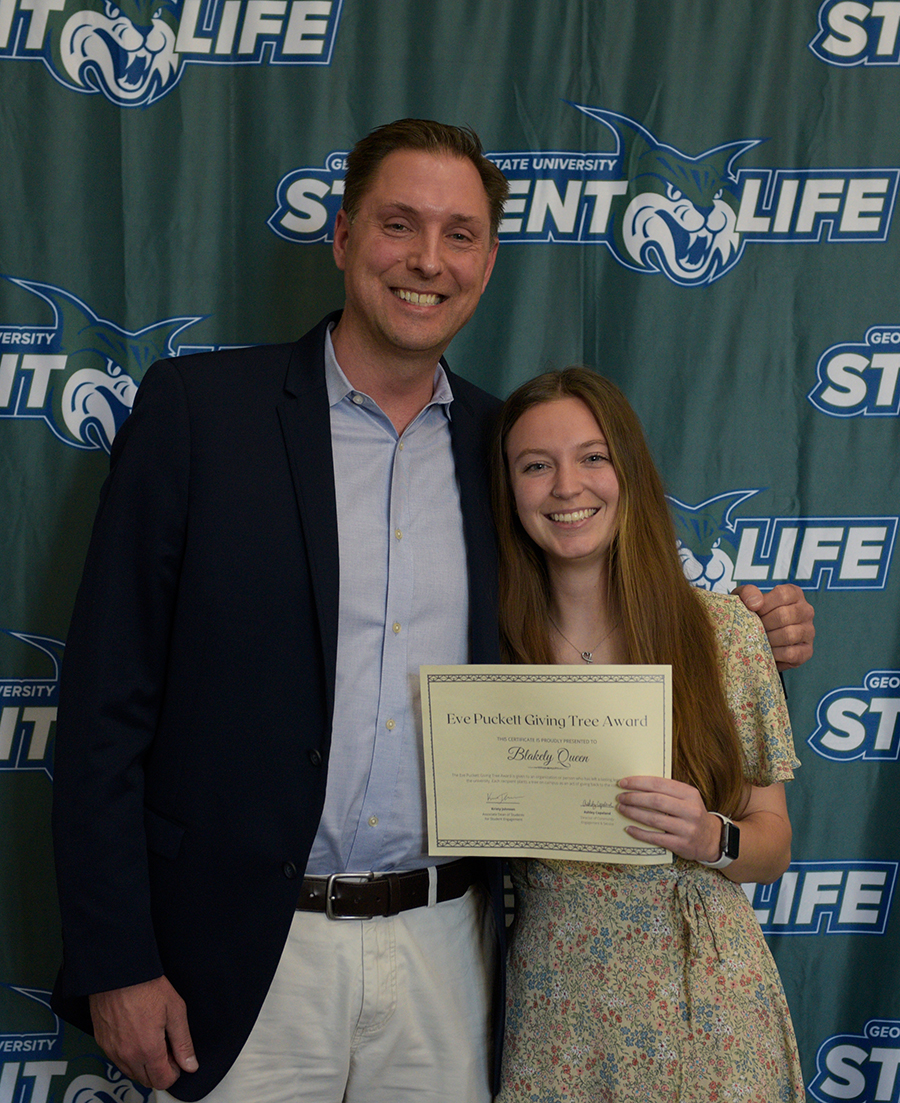 Dr. Scott Butler and the Eve Puckett Giving Tree Award and the President's Volunteer Service Bronze Award winner Blakely Queen.