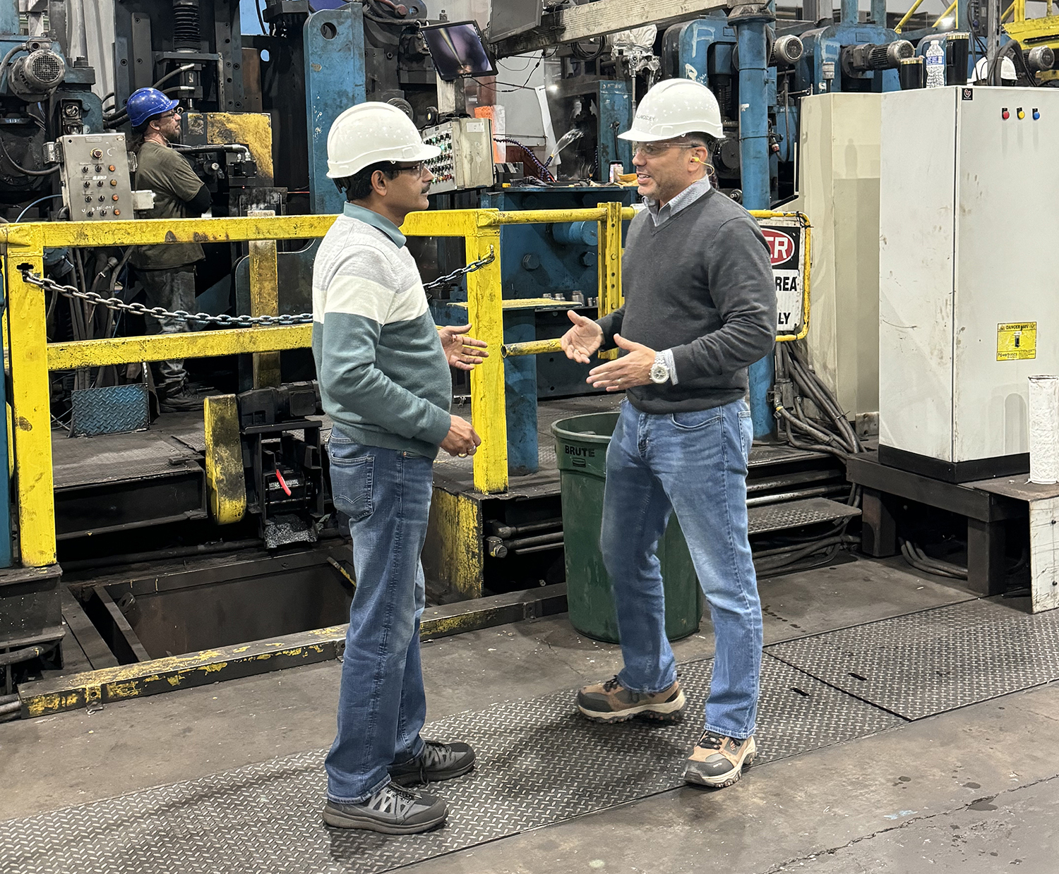 Gerald Mosley (right) talks with a Welspun operations associate.