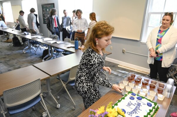 Axel Hawkins cuts a piece of cake in her honor.