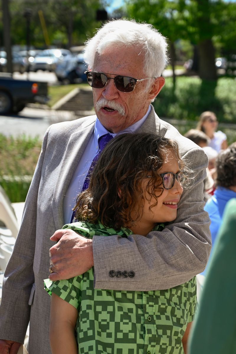 Dr. Kenneth Saladin hugs his grandson.