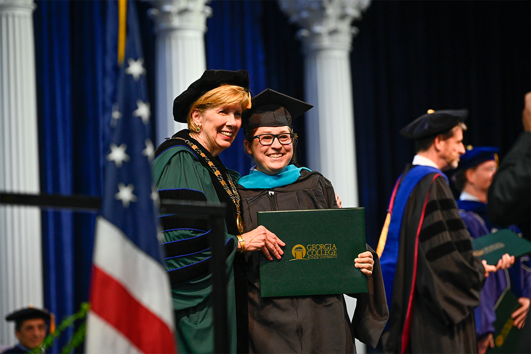 Bailey Clark, at right with President Cox, received her Master's of Public Administration degree at commencement on May 4.