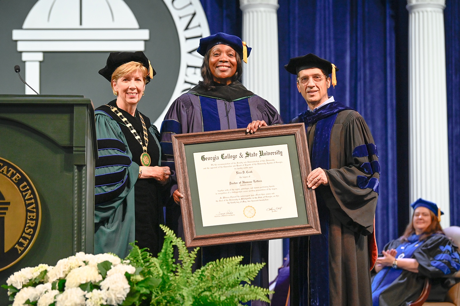 President Cathy Cox and Provost Costas Spirou present Governor Lisa Cook with an honorary degree from GCSU.