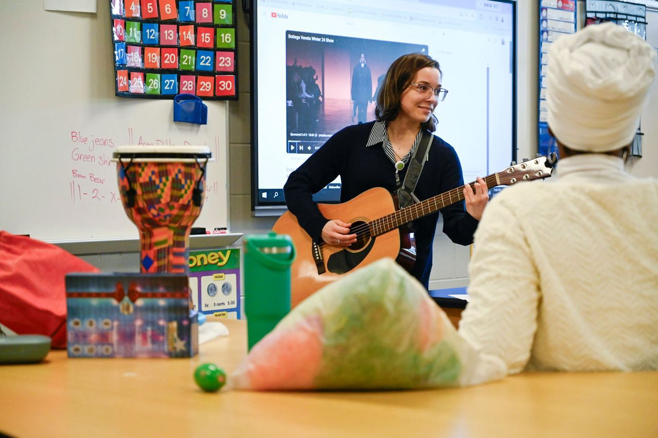 Meghan Jennings plays guitar for students at Oak Hill Middle School.