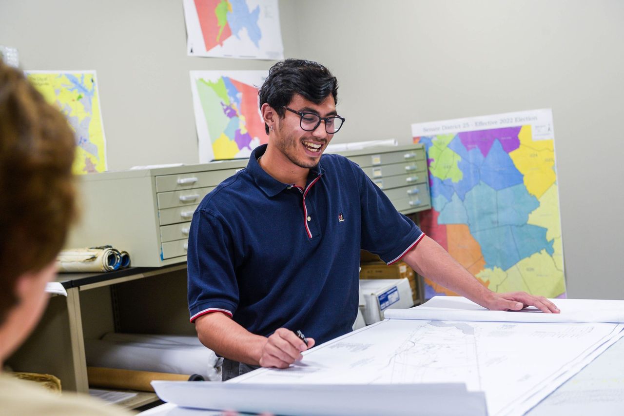 Senior geography major Tanner Adams in the map room at the Baldwin County government building.