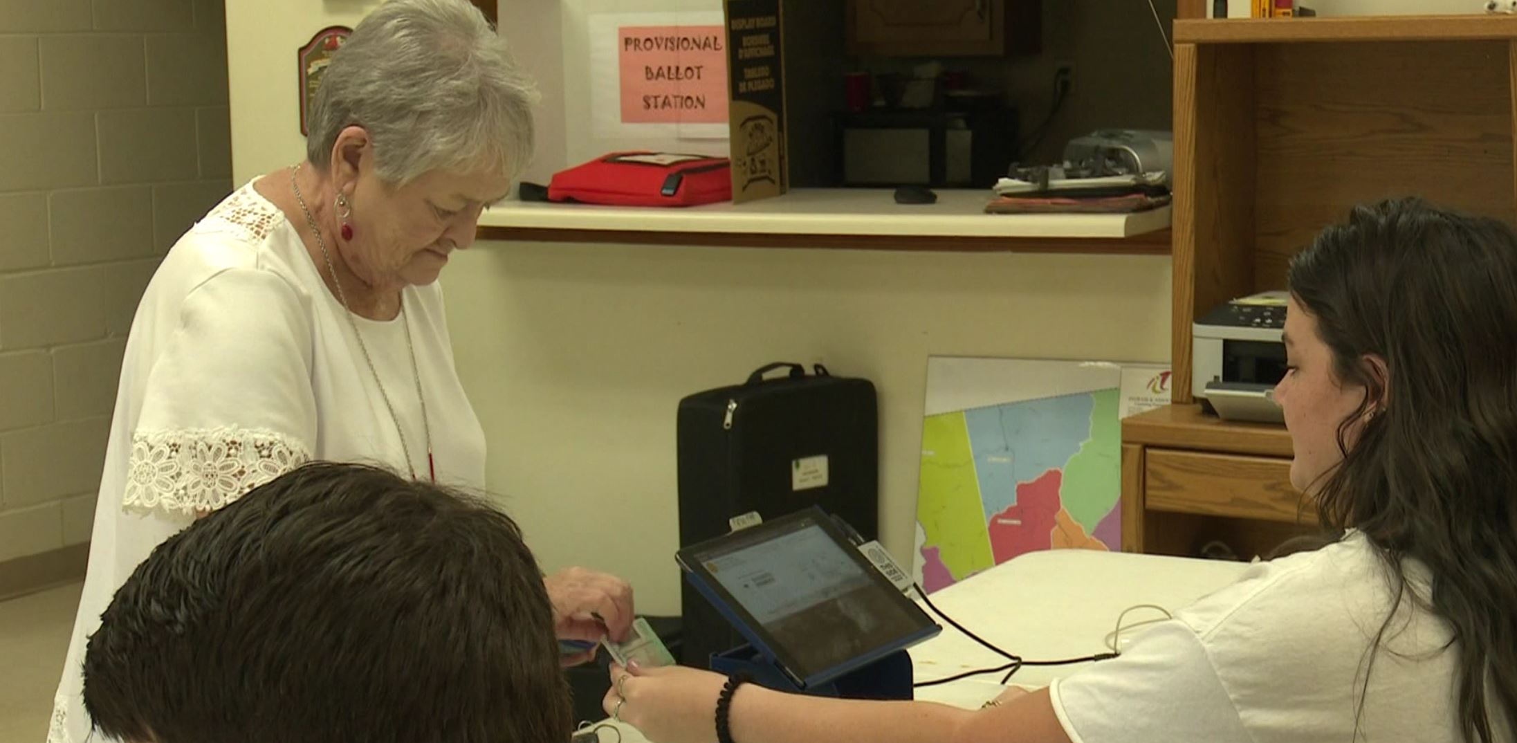 Senior Lauren Trinkwalder takes a voter's ID at the Georgia Primary Election May 21, 2024. (Photo credit: 13WMAZ)