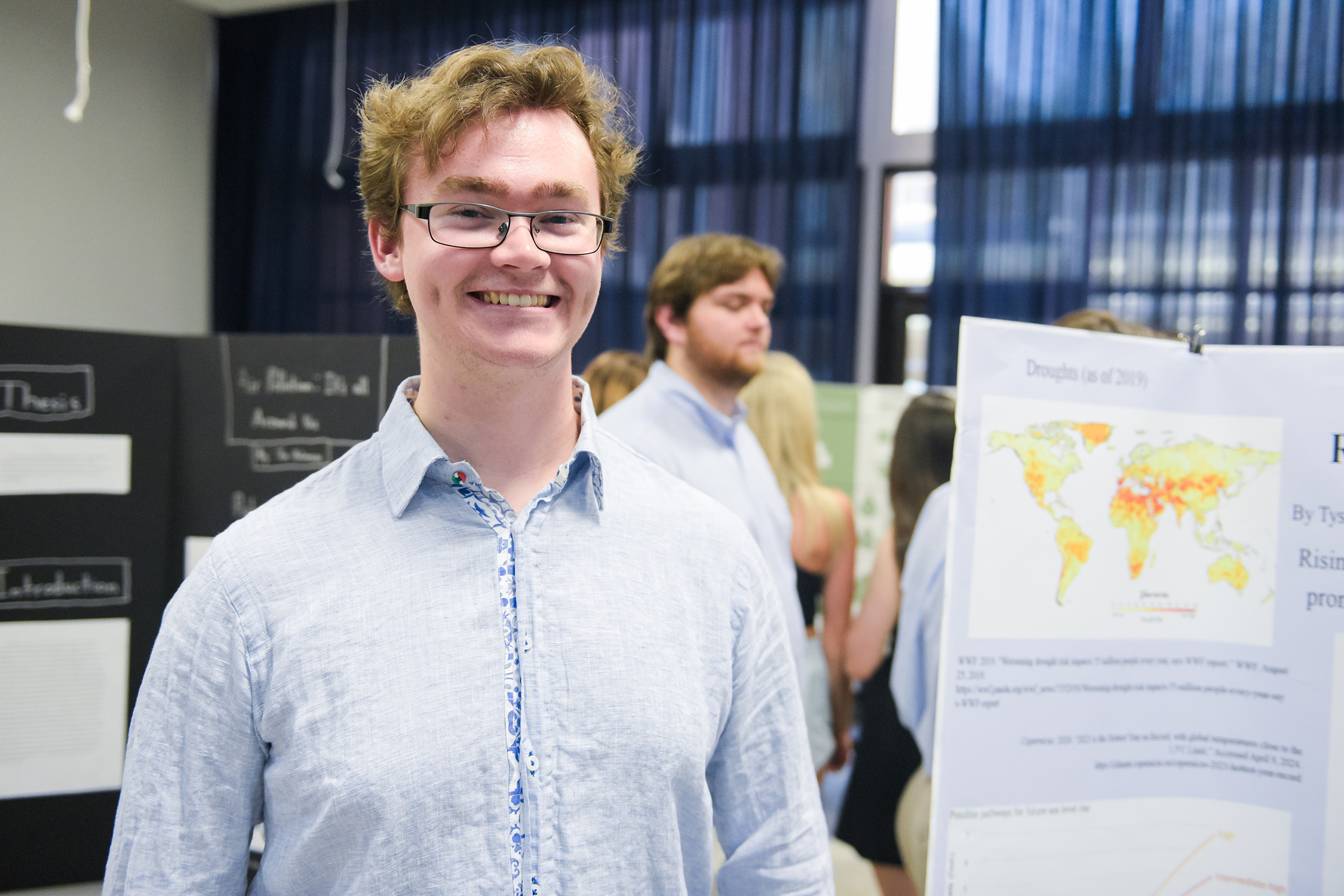 Will Turner stands near his final project "Reshaping the land: Rising and receding water," that he completed with the help of three classmates. Students described their project during the Sustainability Symposium leading up to Earth Day.