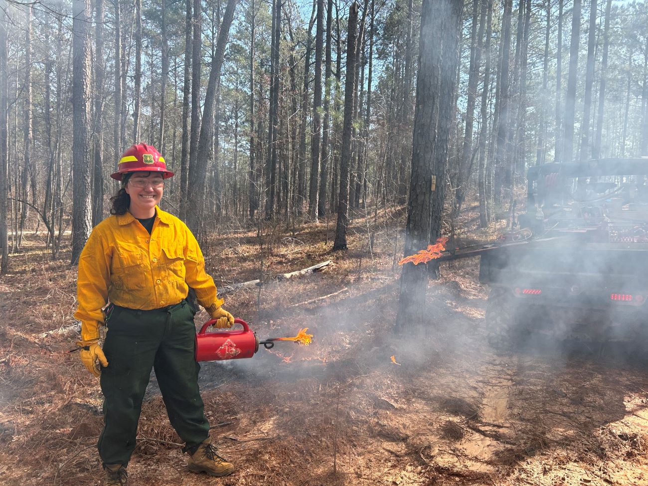 Alumna Molly Hooks at a controlled burn with the U.S. Forest Service last spring.
