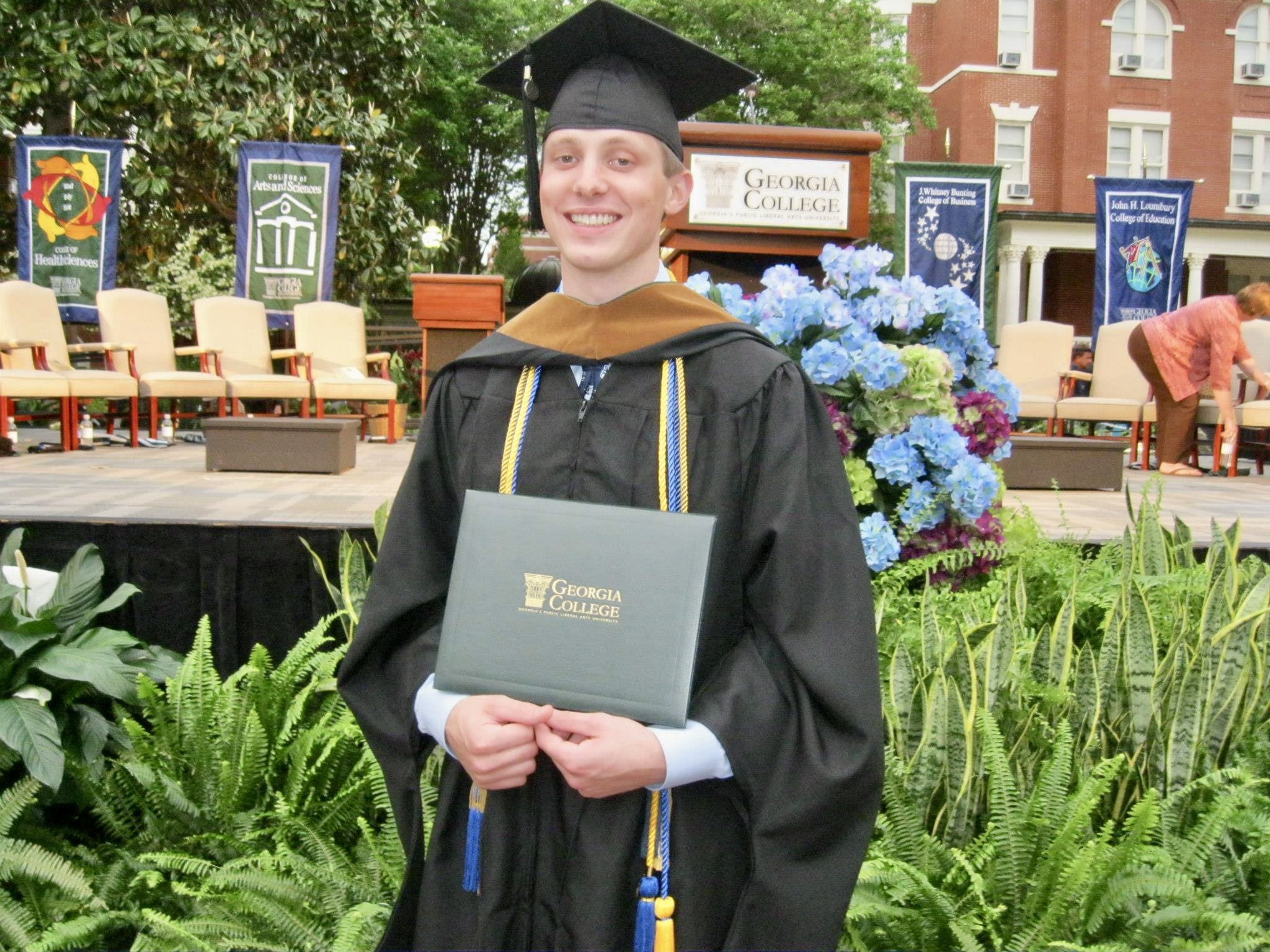 Neas with his degree at graduation.