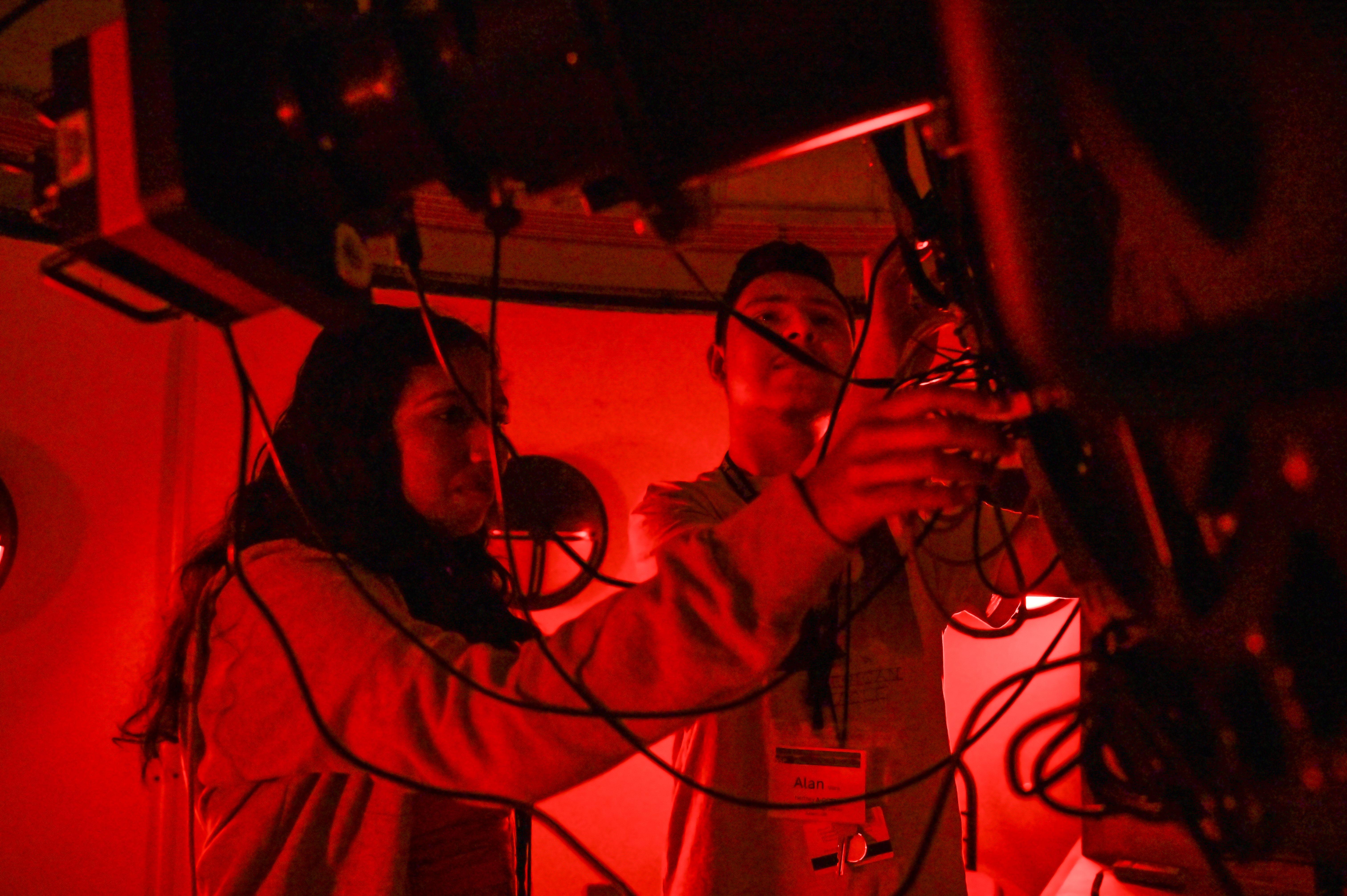 Red colored picture of SSP students at the GCSU observatory telescope.