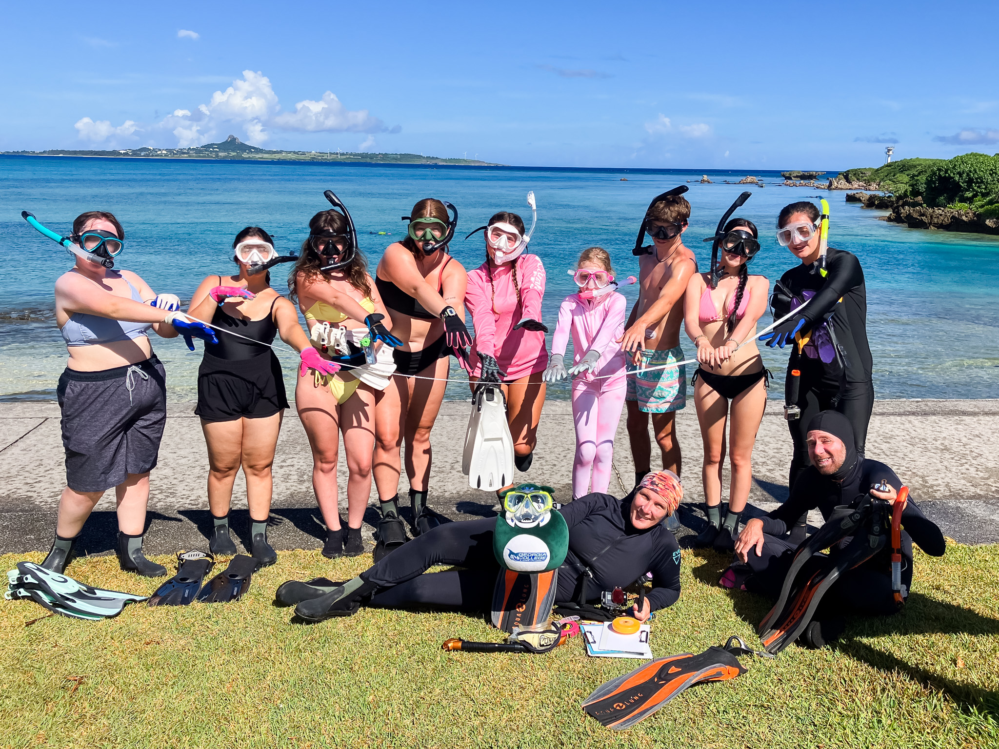 Odeya (second from left), Kali (fourth from left), Angelina (standing, right) and Dr. White (laying, center) pose with lil' Thunder in snorkeling gear.