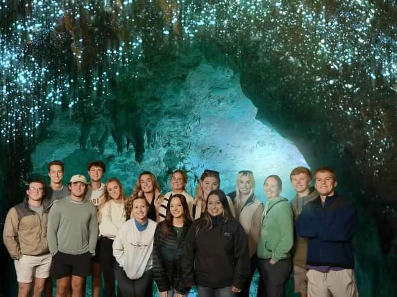 Business abroad students under glow worms in Waitomo Caves.