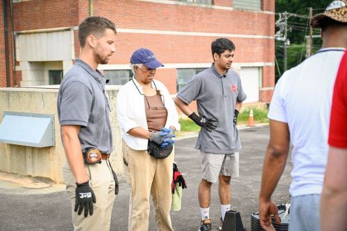 Melanie Byas of Gray, middle, watches a demonstration on how to install solar panels.