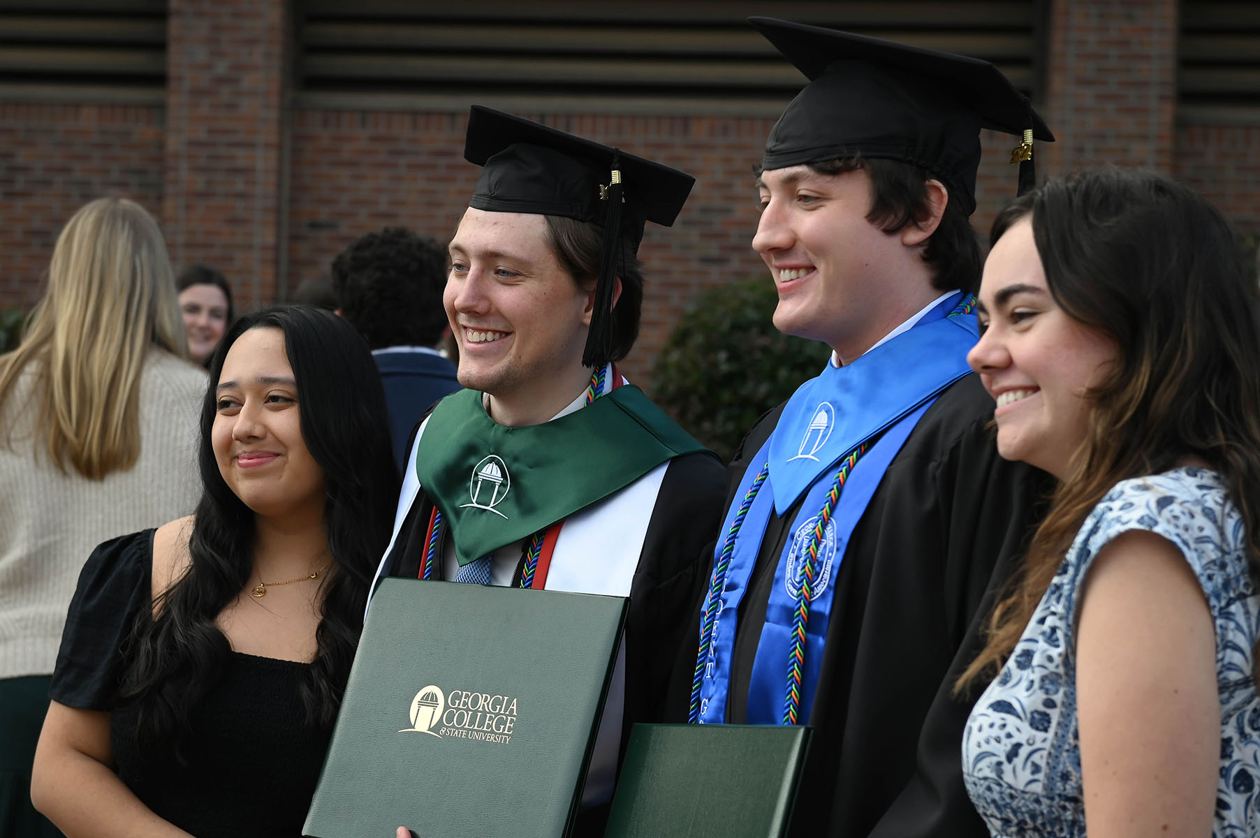 a 2024 graduate with their family after the ceremony