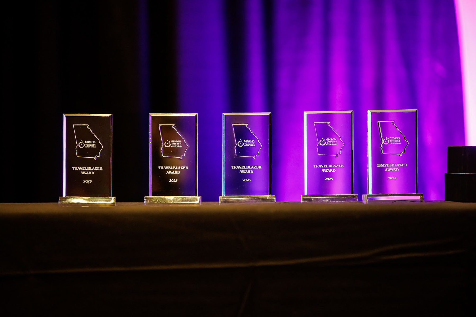 2025 travelblazer award plaques lined up on a table