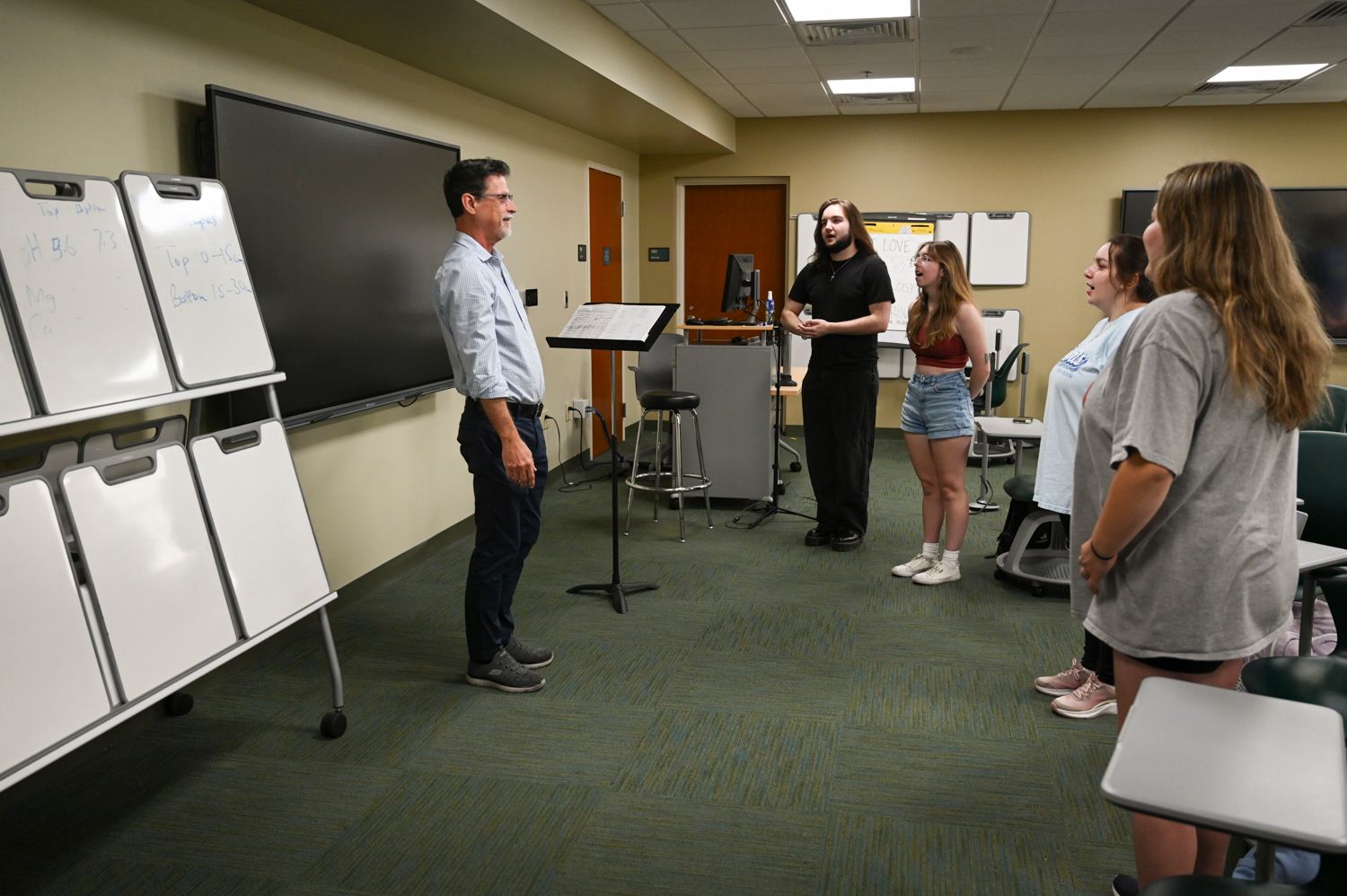 Dr. Scott Dillard leads verbal warm ups with peers.