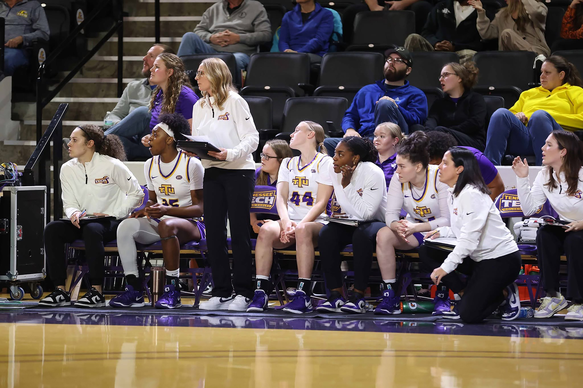 Melanie Walls observes the plays along with her team on the sidelines.