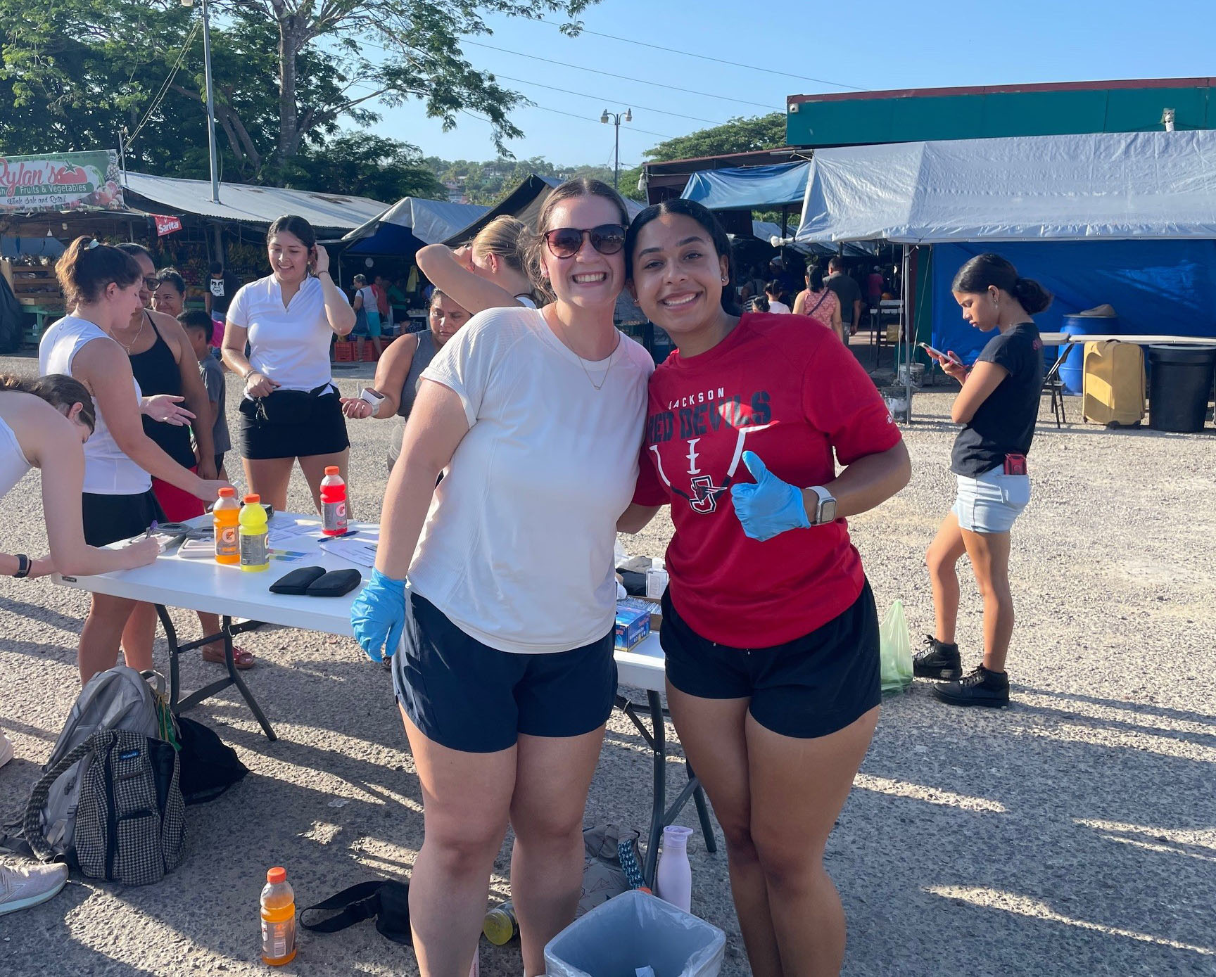Alexa Allen (left) and Brenna Gallman — both juniors in the College of Health Sciences — take a break from providing free health assessments for San Ignacio residents. (Photo: Dr. Kevin Hunt)