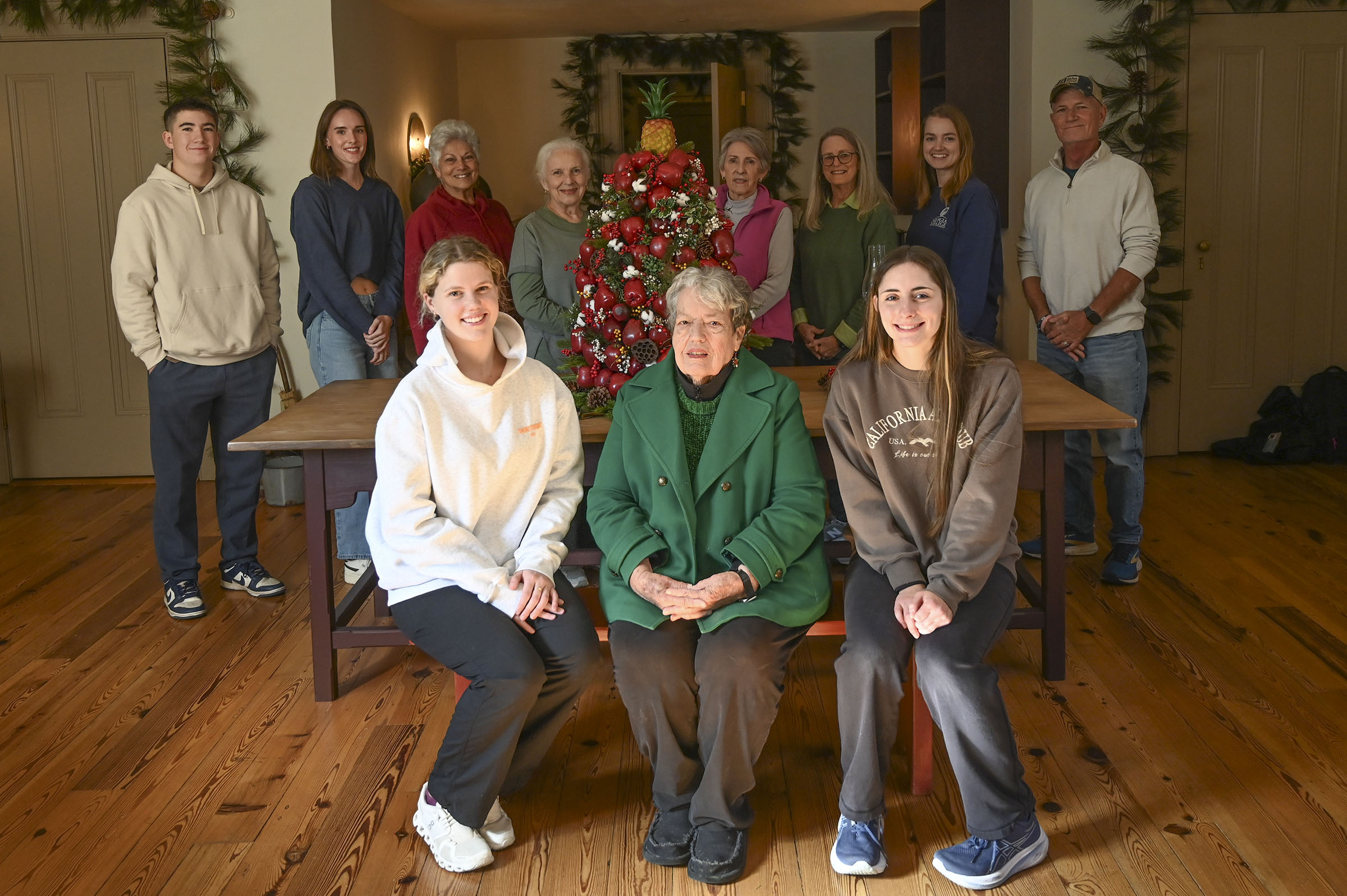 Students, staff and fellow Milledgeville Garden Club members take a break from decorating to gather around Dr. Harriett Whipple, center front. (Photo: Anna Gay Leavitt)