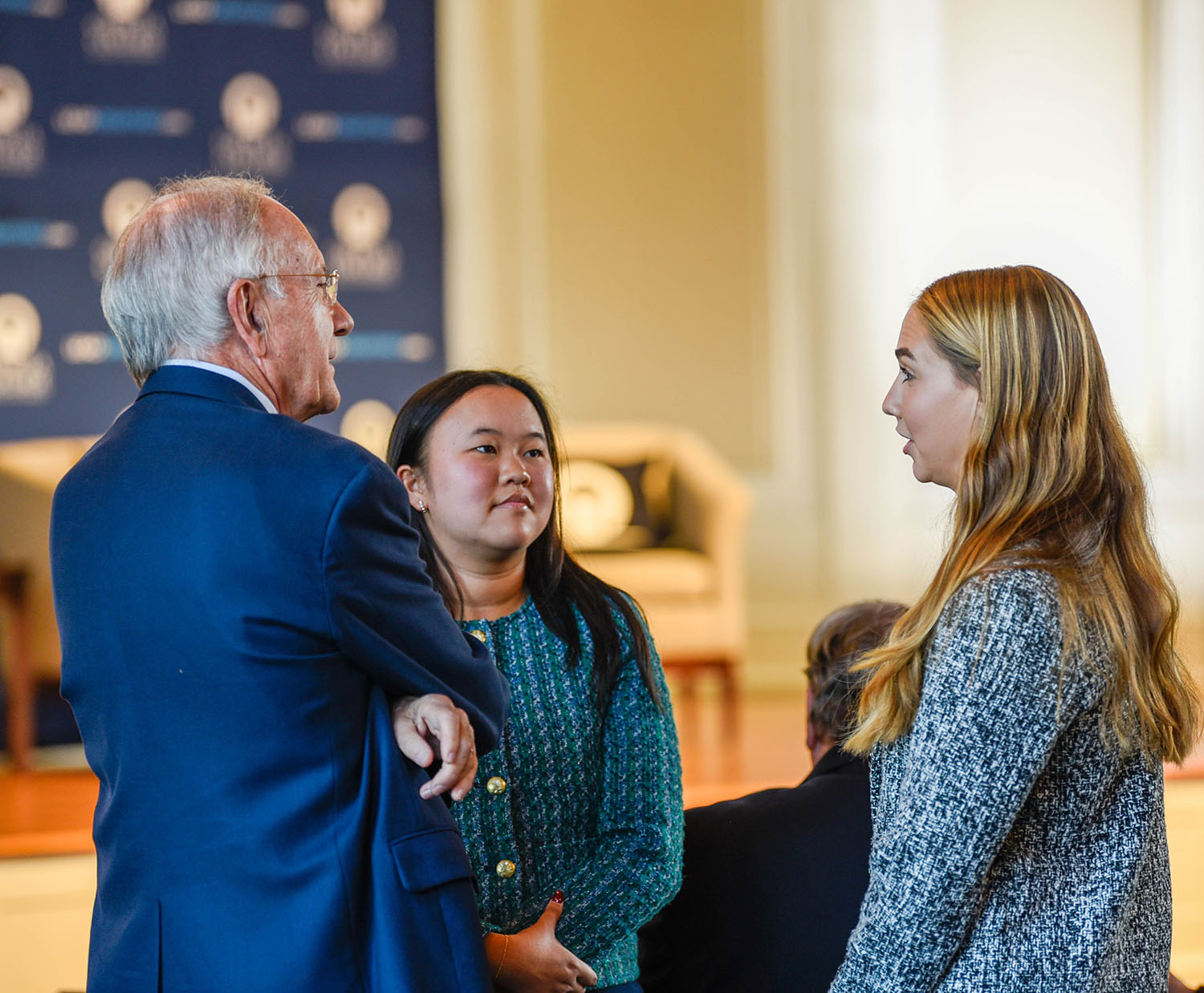 Usery Fellows Bridget Johnson (right) and Kassie Arps (center) speak with Mr. Deriso before the start of the program. (Photo: Janelle Tyler)