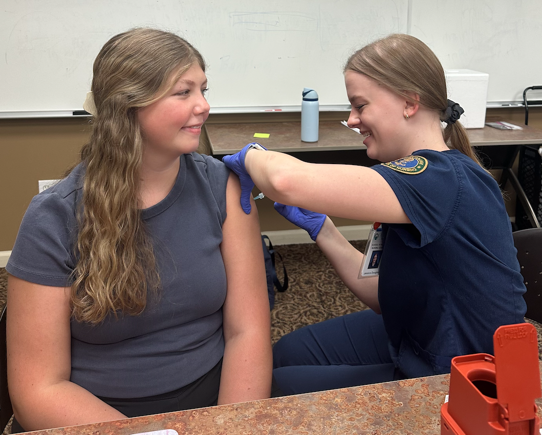 <span style="font-kerning:none;">Nursing major Jessica Douglas gives the flu vaccine at a pop-up clinic held in Wells Hall dormitory. </span>(Photo: Nursing major MaKenzie Curry)