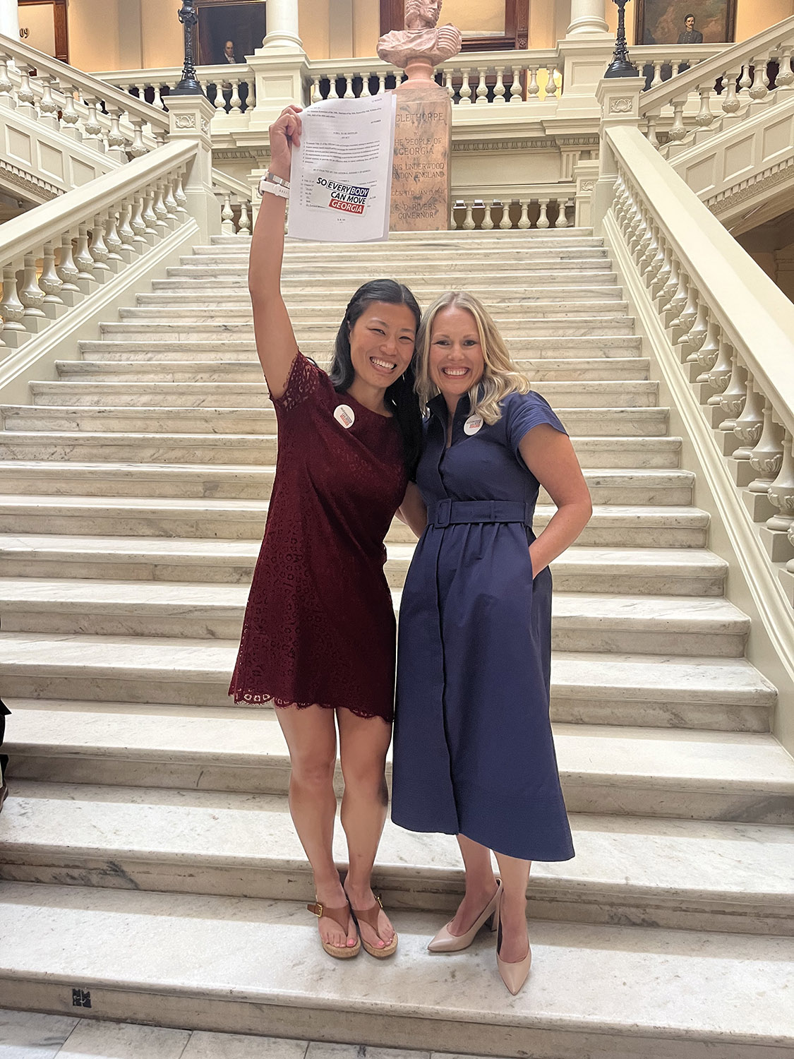 Cristalei Polk ('16) and legislative co-lead Rachael Auyer celebrate on the steps in the Georgia Capitol. (Photo: Cristalei Polk)