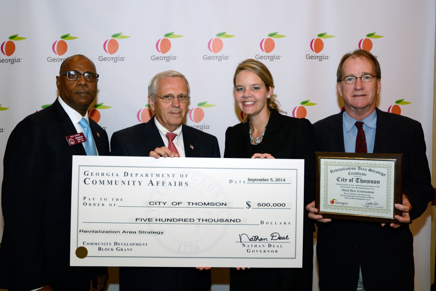 Rep. Mack Jackson presents a check to city officials to revitalize Thomson.