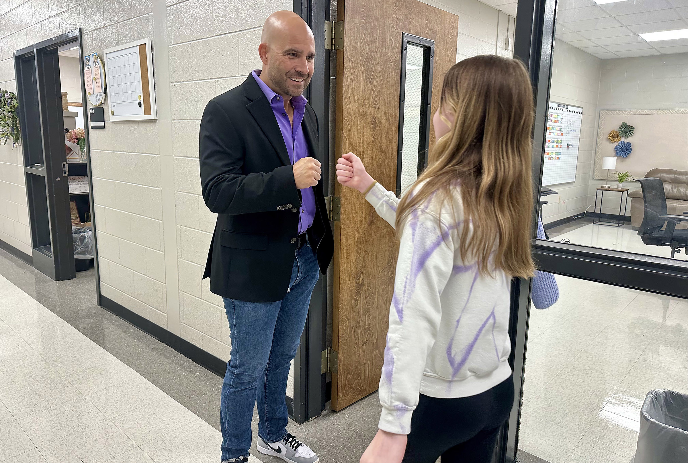 Dr. Marc Feuerbach greets a Superintendent Advisory Council student before the meeting for Cartersville Elementary School. 