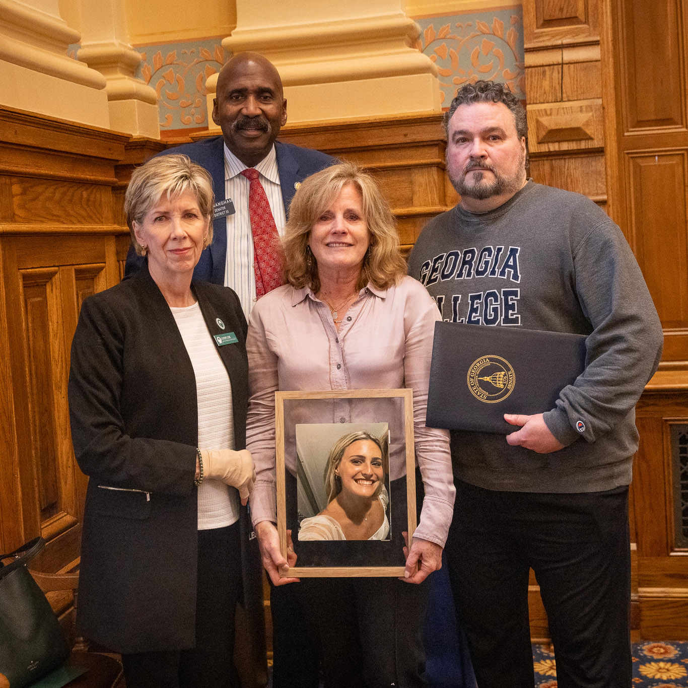 Abby's parents at the state legislature. From left: President Cathy Cox, State Sen. Randal Mangham, Kelly Savoie and Marc Savoie. (Photo: Georgia State Senate press office)