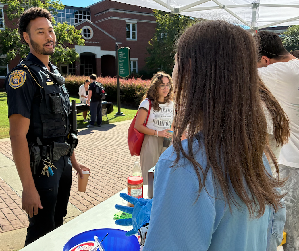 Officer Johnson engaging with students on campus during patrol. (Photo: Gil Pound)