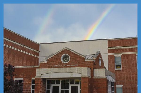 A beaming rainbow makes the perfect backdrop for the College of Arts & Sciences building