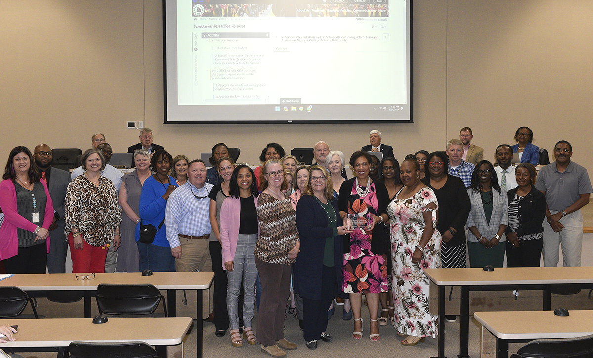 SoCPS Executive Director Angela Criscoe and BCSD Superintendent Dr. Noris Price, at center, pose with BCSD administrators