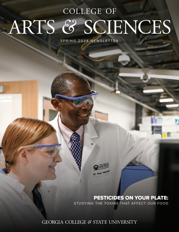 The cover photo, Dr. Fakay stands with a student in lab gear.