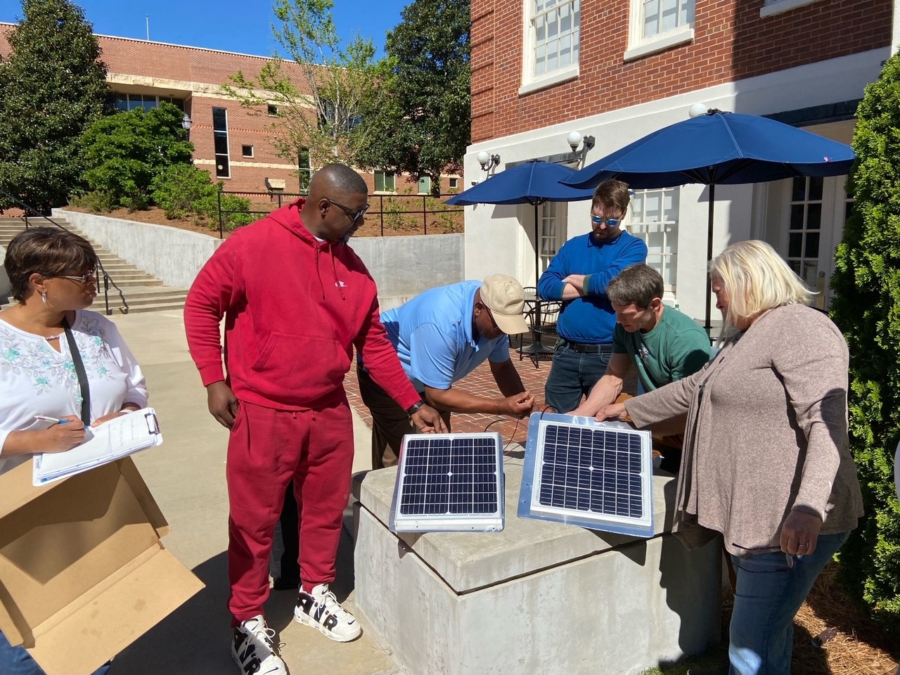 PIN class members inspect solar panels last spring.